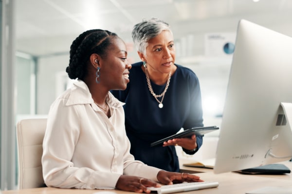 Computer, teamwork and review with business women in office for accounting discussion, audit feedback or talk. Tech, portfolio manager and collaboration with mentor, tablet and finance agency report