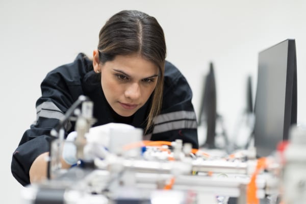 Female engineer working on robot