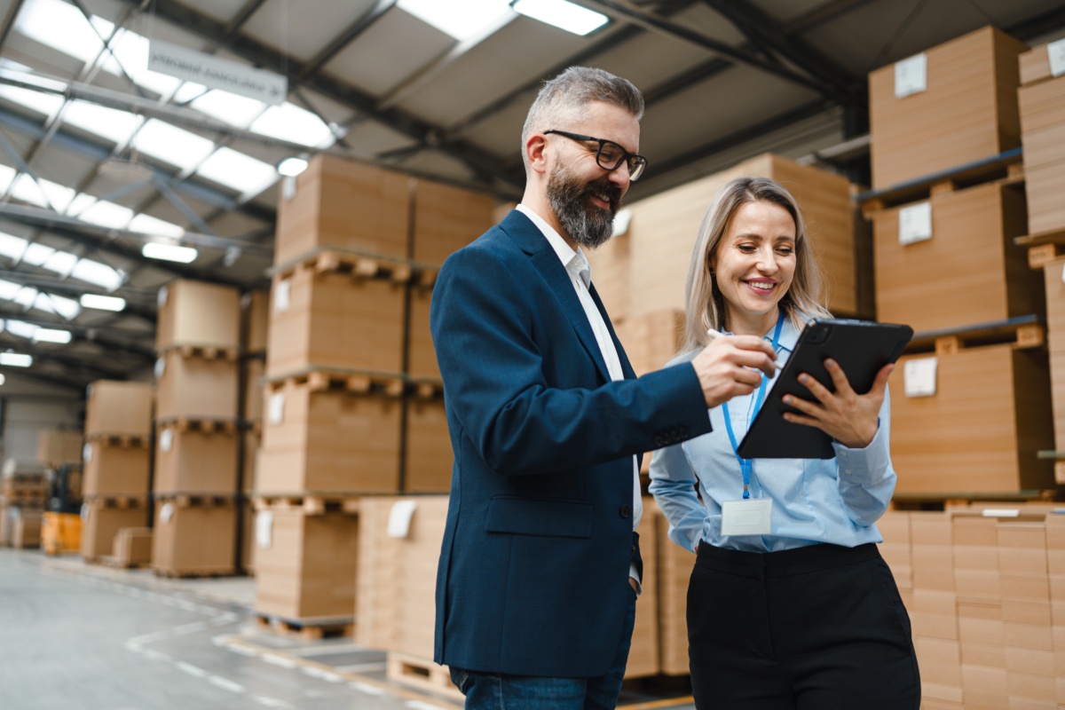 Two warehouse colleagues discussing stock