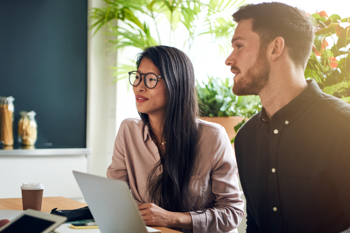 Two colleagues sat at a desk together