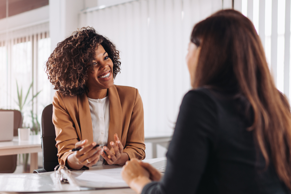 Travel agent talking to a customer over a desk