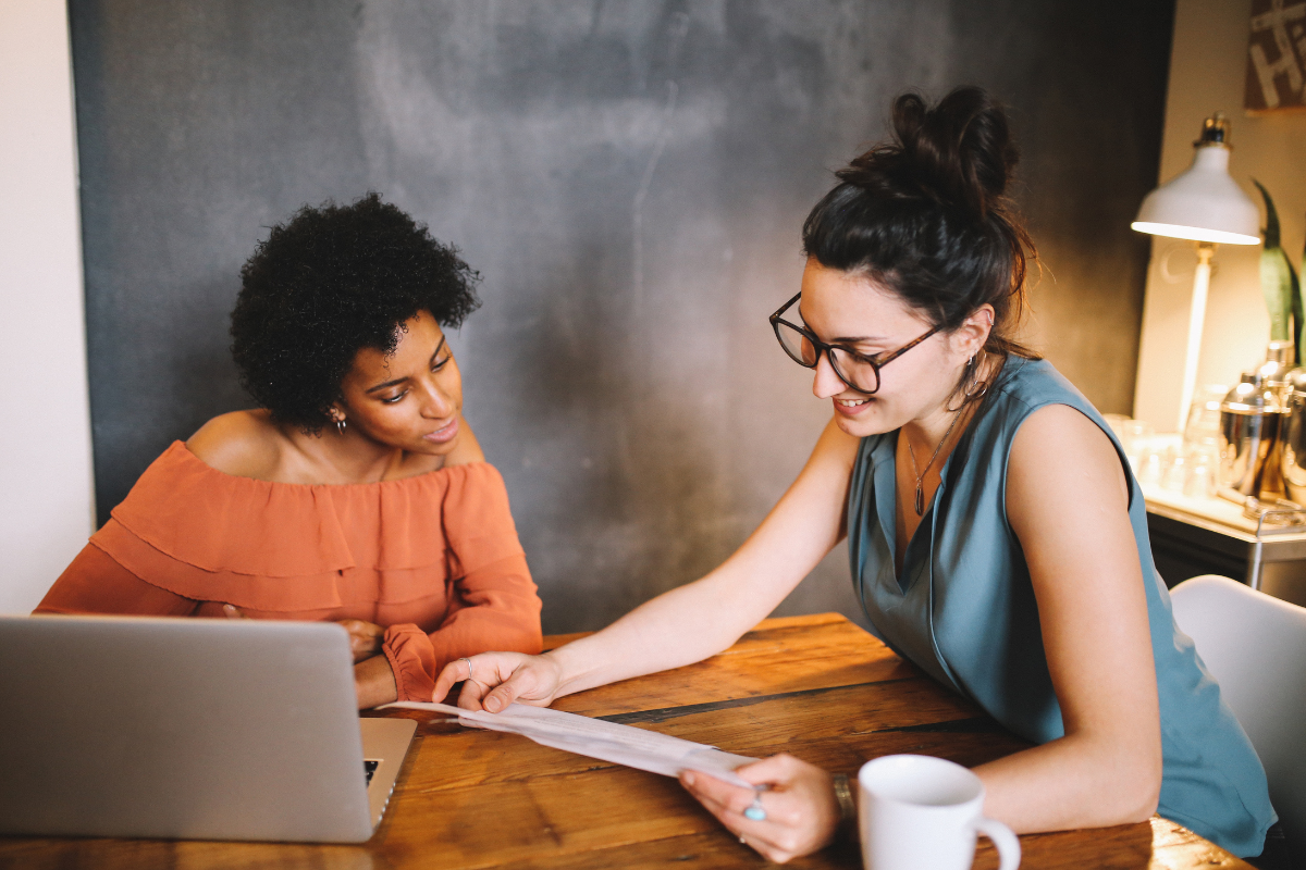 Two people working together on a laptop