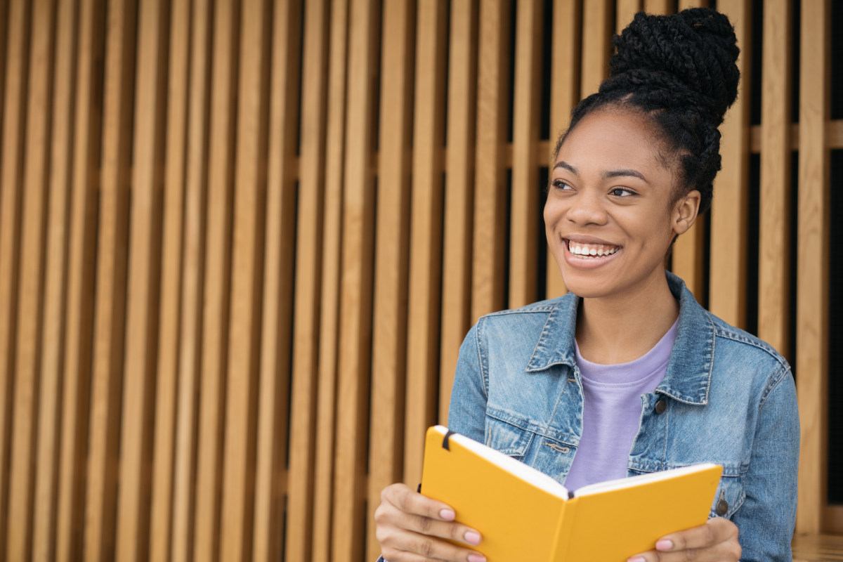 Portrait of smiling confident student studying, learning something